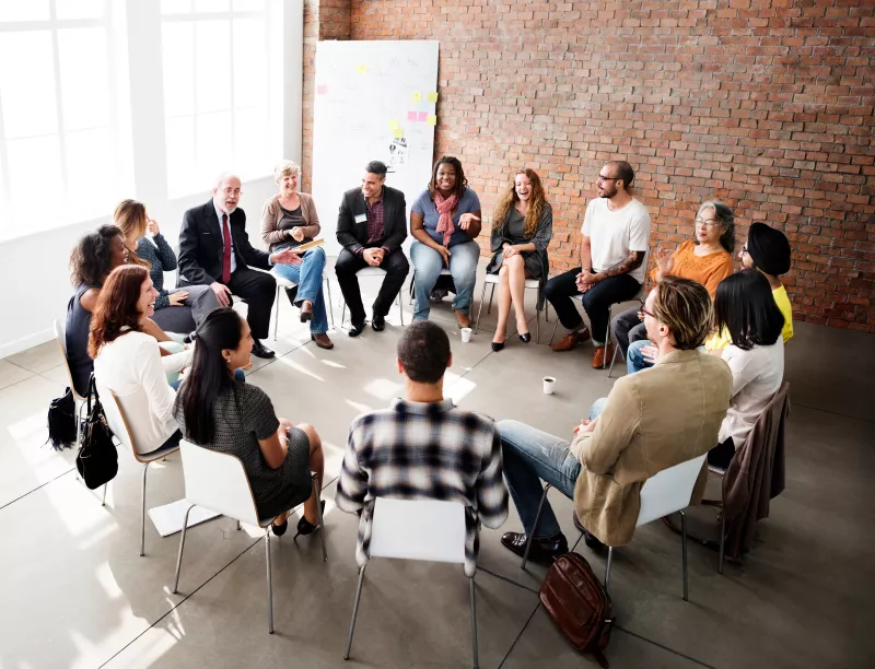 People in a discussion seated in a circle